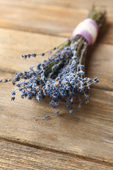 Obraz na płótnie Canvas Lavender flowers on color wooden background