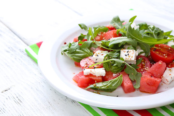 Salad with watermelon,tomatoes,  feta, arugula and basil leaves