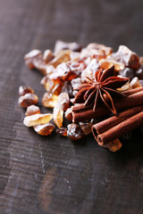Brown sugar cubes and reed sugar, spices on wooden background