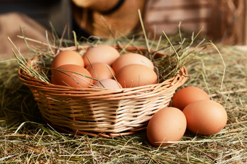 Eggs in wicker basket on table close-up