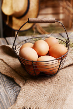 Eggs in wicker basket on table close-up