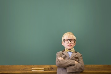 Cute pupil dressed up as teacher in classroom
