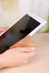 Female hands holding credit card and computer tablet