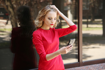 Fototapeta premium Beautiful young girl outdoors near building