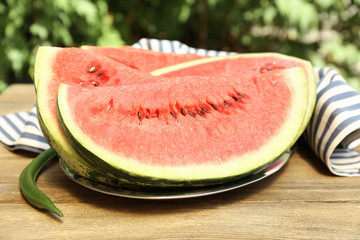 Fresh slice of watermelon on table outdoors, close up