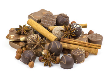 chocolate, spices and nuts on white background