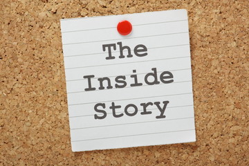 The phrase The Inside Story on a cork notice board