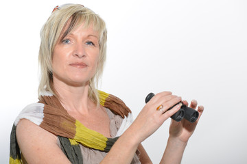 Blonde businesswoman with scarf looking with binoculars