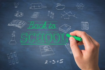 Composite image of hand holding blue chalk