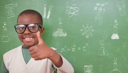 Composite image of cute pupil showing thumbs up
