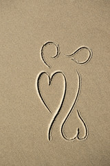drawing of two hearts on sand