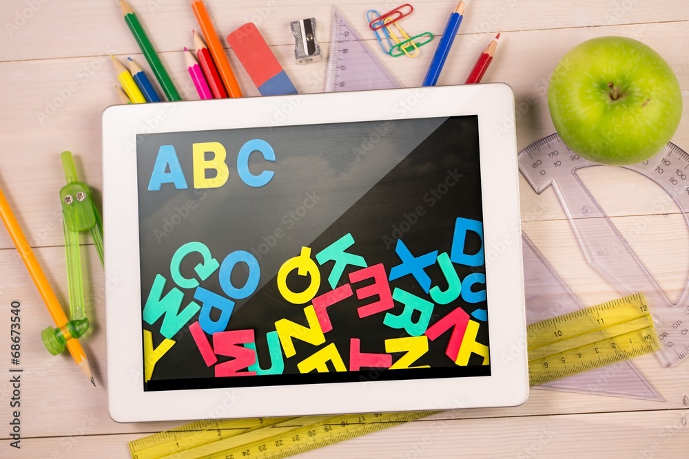 Poster composite image of digital tablet on students desk