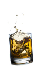 Scotch whiskey splashing out of glass. Isolated on white  backgr