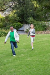 Fototapeta premium Happy young friends running towards the camera