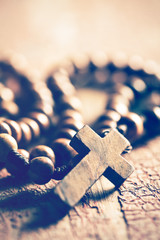 rosary on old wooden table