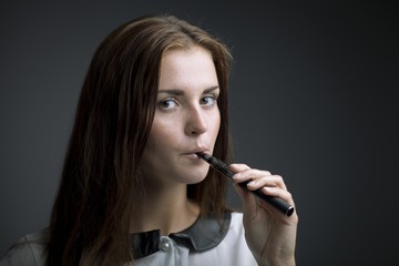 Elegant beautiful woman holding e-cigarette