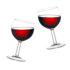 Cheers! Two glasses of red wine, tilted, isolated on white .