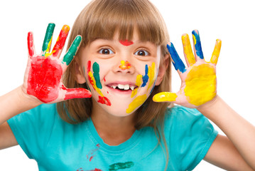 Portrait of a cute girl playing with paints