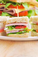 Club Sandwich with Cheese, Pickled Cucumber, Tomato and ham. Gar
