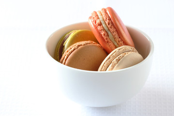 colourful french macaroons on white background