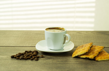 cup of coffee and cookies on the wooden table