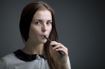 Elegant beautiful woman holding e-cigarette