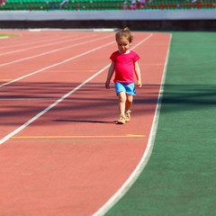 little girl child involved in athletics at the stadium