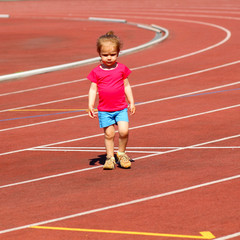 little girl child involved in athletics at the stadium