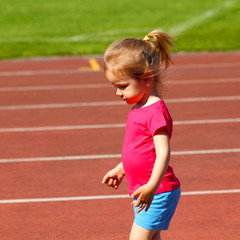 little girl child involved in athletics at the stadium