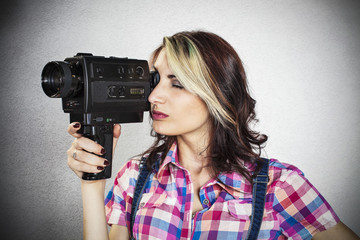 Beautiful girl using a video camera