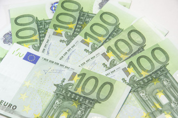 Close-up of 100 Euro banknotes isolated on white background.
