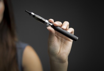 E-cigarette in woman's hand close up