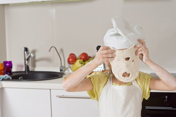 Little girl playing with a dough mask
