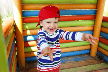 Fototapeta na wymiar portrait of happy baby boy on playground