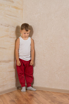 Cute Little Mad Kid on Light Brown Wooden Walls