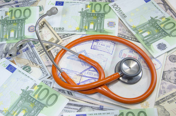 Medical still life with stethoscope, money and passport. Isolate