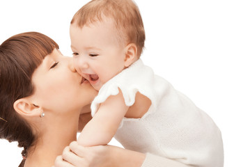 happy mother kissing baby