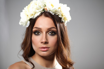 Portrait of a beautiful woman with flowers in her hair. Fashion