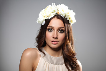 Portrait of a beautiful woman with flowers in her hair. Fashion