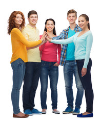 Obraz premium group of smiling teenagers making high five