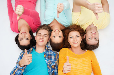 group of smiling teenagers showing thumbs up