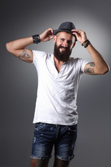 Portrait of handsome bearded man in hat standing , isolated on