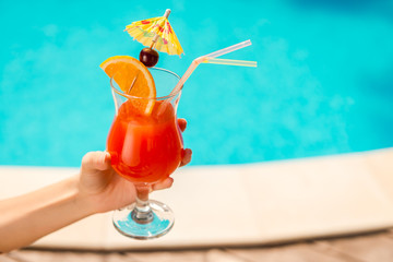 Refreshing drink in her hand.