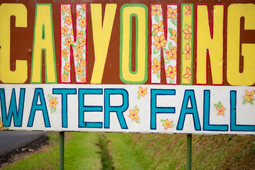 Word Canyoning and water falls painted on wooden board