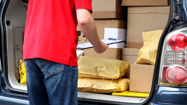 Delivery man taking package from car film