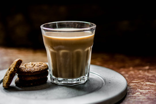 Coffee with cookies on rustic background