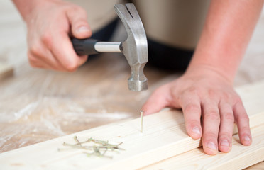 Man driving a nail