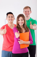 Happy students showing thumbs up sign