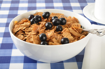 Bowl of bran and corn flakes with blueberries