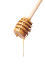 Honey dripping from wooden dipper
